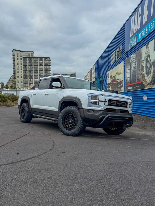 2026 BYD Shark 6 dual cab PHEV in Polar White fitted with ROH Assault Matt Black alloy wheels and all-terrain tyres — front three-quarter view at Mag & Turbo Tyre & Service Centre