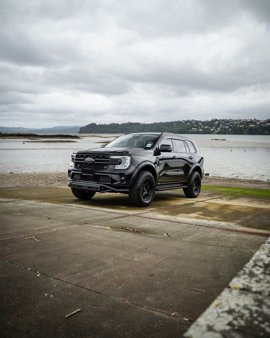 2023 Ford Everest Platinum in black fitted with Covert RTO6 18x9 Matt Black alloy wheels and Atturo Trail Blade X/T all-terrain tyres — front three-quarter view
