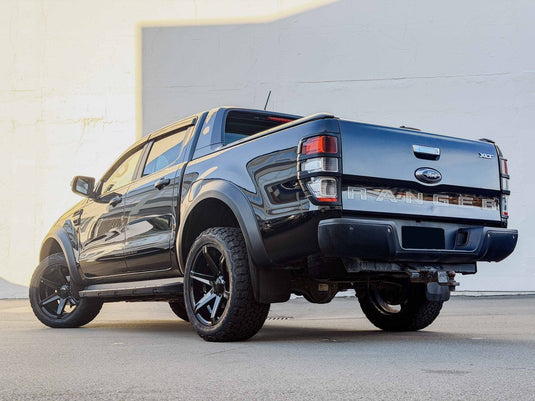 2020 Ford Ranger XLT dual cab in Shadow Black with flared arches fitted with Covert RV2 Gloss Black alloy wheels and 285/50R20 A/T tyres — rear three-quarter view at Armstrong's