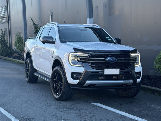 2024 Ford Ranger Wildtrak 4x4 dual cab in Arctic White fitted with Covert RV5 Gloss Black alloy wheels — front three-quarter view
