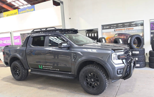 2026 Ford Ranger dual cab in Meteor Grey with roof rack fitted with Covert RTO6 18x9 Matt Black alloy wheels and all-terrain tyres — front three-quarter view at Offroad Tyres NZ