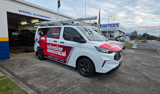 2026 Ford Transit custom van with Silvester Electrical trade wrap fitted with BGW Beast 17x8 Gunmetal alloy wheels — front three-quarter view at Carter's Tyre Service