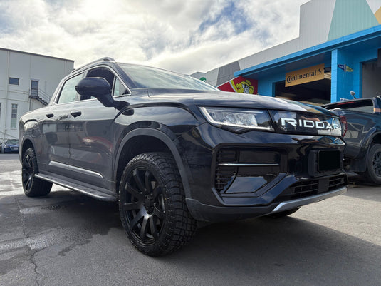 2026 Geely Riddara RD6 4WD dual cab in Phantom Black fitted with Covert RV3 Matt Black alloy wheels and Terra Frontier A/T 275/45R20 all-terrain tyres — front three-quarter view