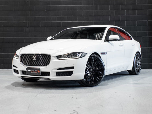 2016 Jaguar XE 20d AWD sedan in Yulong White fitted with BGW Black Widow Gloss Black alloy wheels — front three-quarter view at Precision Autos