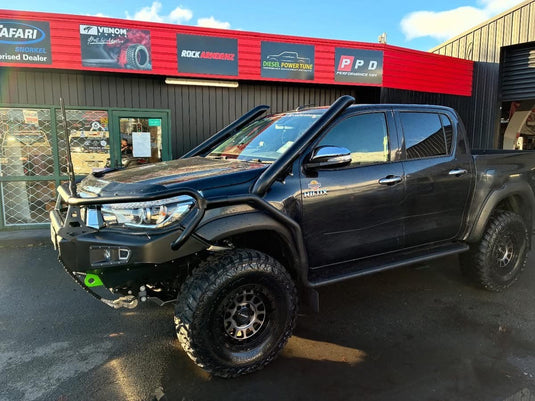 2022 Toyota Hilux SR5+ dual cab in Graphite with Safari snorkel, bull bar, winch, and flared arches fitted with ROH Assault Tint alloy wheels and M/T tyres — front three-quarter view at PPD Performance